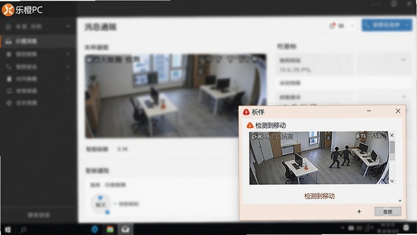 乐橙PC软件报警消息通知界面截图，电脑屏幕右下角弹出一条报警提示框，提示框内有监控画面缩略图和“检测到移动”的文字说明，背景是模糊的软件主界面，突出软件的智能侦测与即时提醒功能