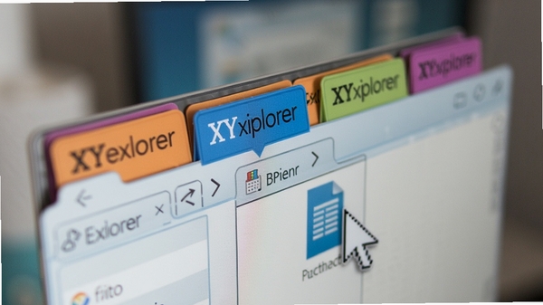 XYplorer标签式浏览功能特写，展示多个彩色标签页在窗口顶部排列，其中一个标签处于激活状态，鼠标指针正拖拽一个文件到另一个标签页上，画面聚焦于多任务处理场景，背景虚化处理，突出标签切换的便捷与高效。