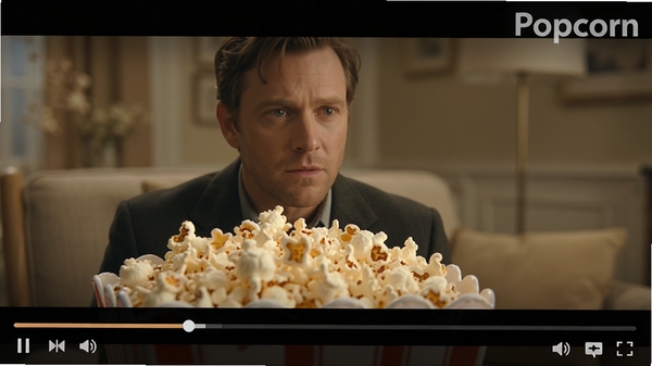 Popcorn视频播放界面细节图，画面中显示一个高清电影暂停画面，视频底部有进度条和控制按钮，界面右上角显示Popcorn软件名称水印，整体色调柔和，突出播放画质的细腻与清晰