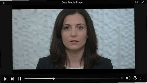 The Core Media Player 主界面预览图，深色背景，中央视频播放区正播放高清测试画面，底部是简洁的黑色控制条，包含播放/暂停、进度条、音量调节等按钮，整体风格现代、专业，无任何文字遮挡