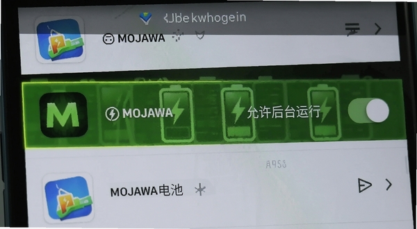 MOJAWA电池优化设置界面截图,手机屏幕上显示应用列表,MOJAWA应用被高亮显示,旁边有“允许后台运行”开关,背景为绿色电池图标,画面清晰,指导性强