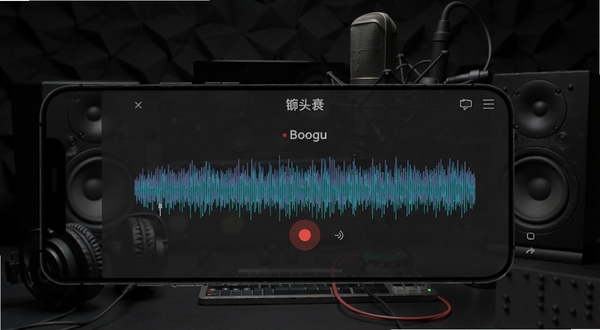 榔头软件录音与实时预览界面,手机屏幕显示红色录音按钮和跳动的音频波形,背景区域为深色工作室风格,画面中有耳机、麦克风、扬声器等元素,软件名称榔头在界面中央,适配Boogu模型生成