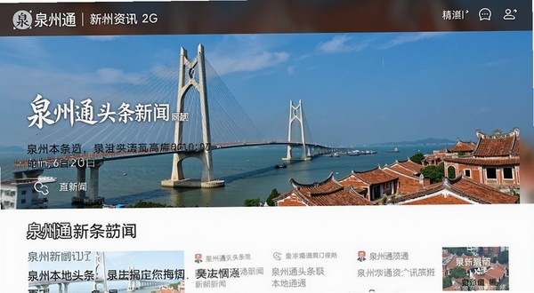 泉州通 新闻资讯页面 手机屏幕上显示泉州本地头条新闻 背景为泉州湾跨海大桥与古厝红砖建筑 明亮清晰 现代感